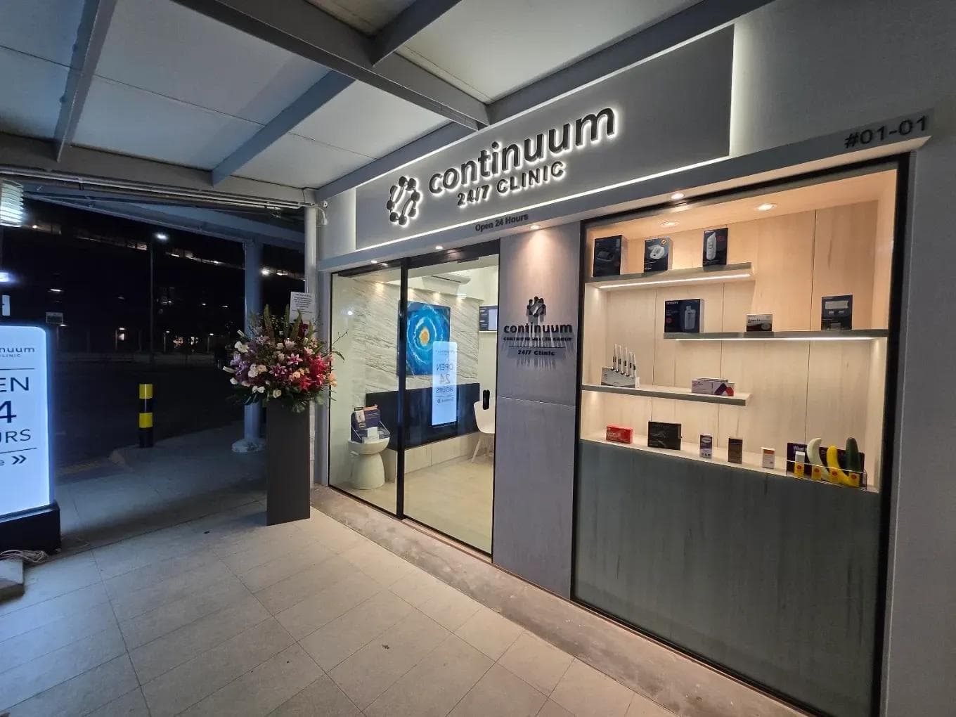 The Continuum 24/7 Clinic shopfront lit up at night at 274D Compassvale Bow, unit #01-01, with its Open 24 Hours sign